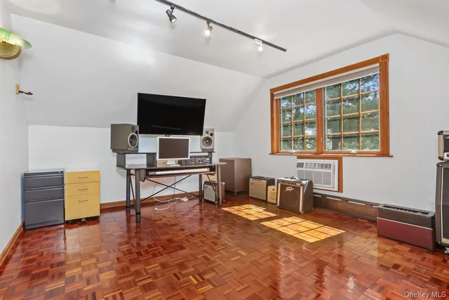 a workspace with furniture window and a flat screen tv