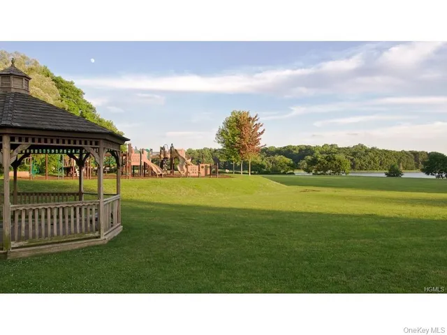 a view of a street sign under a large tree