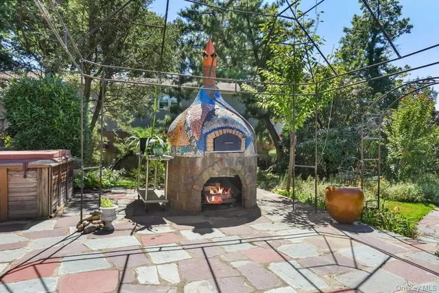 a view of a chair and fire pit in backyard