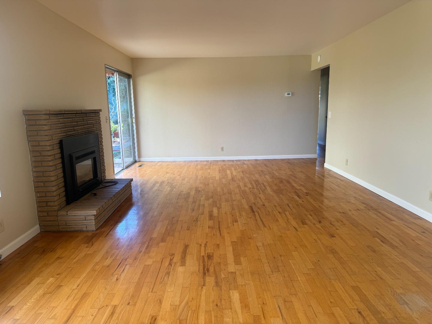 1373 Kimball Avenue Seaside, CA 93955 - Photo 4 of 13 a view of empty room with wooden floor and fireplace