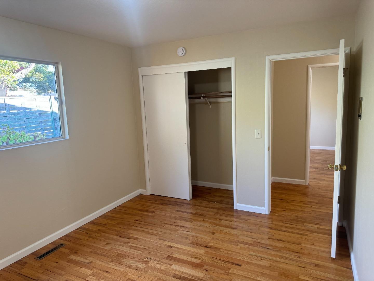 1373 Kimball Avenue Seaside, CA 93955 - Photo 8 of 13 a view of an empty room with wooden floor and a window