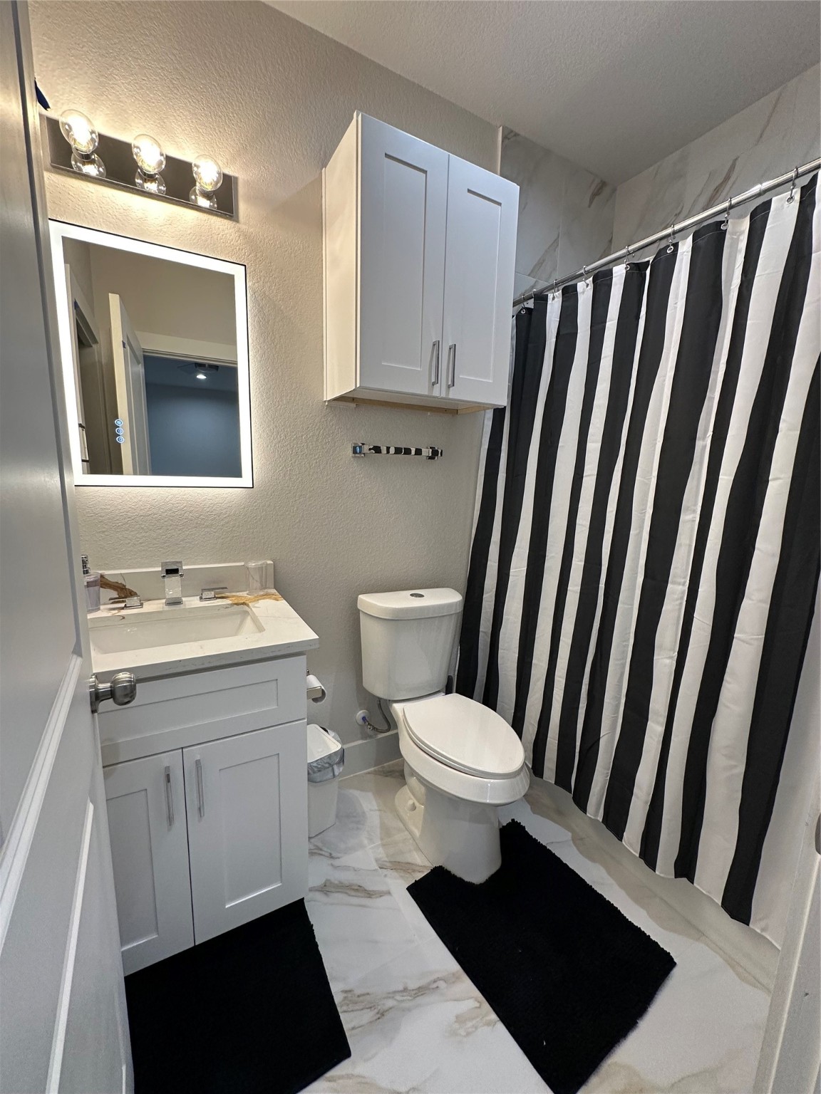 4513 Reed Road, Unit B Houston, TX 77051 - Photo 25 of 29 a bathroom with a toilet a sink a vanity and mirror