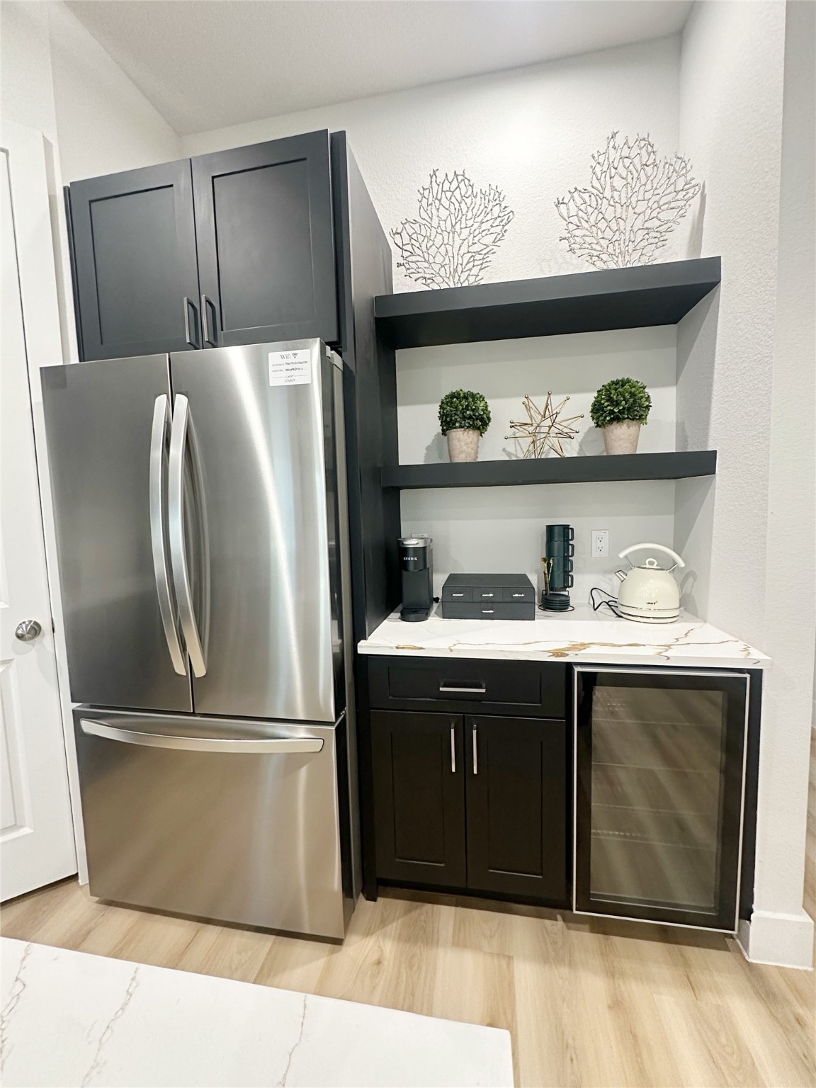 4513 Reed Road, Unit B Houston, TX 77051 - Photo 4 of 29 a kitchen with a refrigerator and a more wooden cabinets