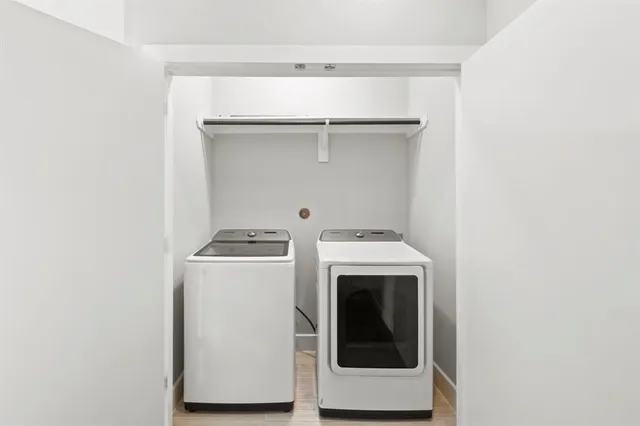 a view of washer and dryer with kitchen in the background