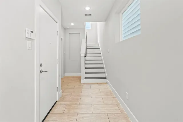 a view of a hallway with stairs and a hallway