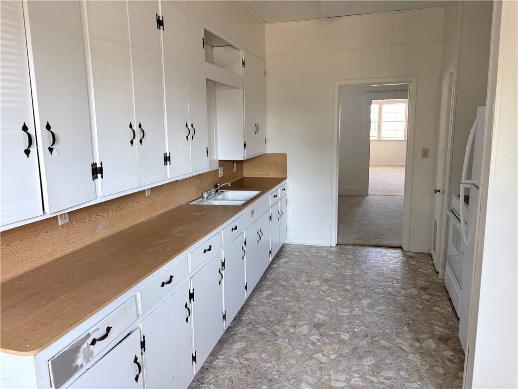10356 Main Street Somerville, TX 77879 - Photo 11 of 19 a kitchen with granite countertop white cabinets and sink
