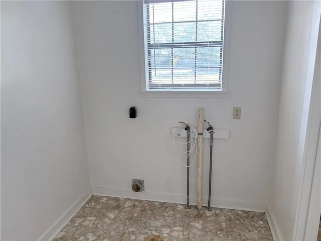 an empty room with closet and a bathroom view