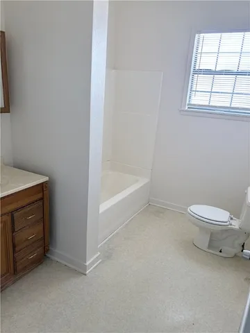 an empty room with a chandelier fan