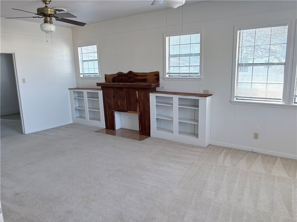 10356 Main Street Somerville, TX 77879 - Photo 4 of 19 an empty room with windows and cabinet