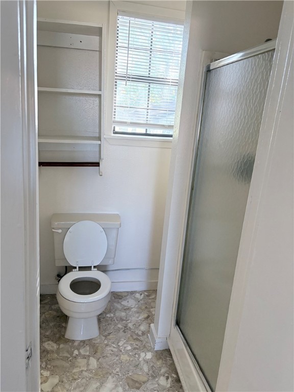10356 Main Street Somerville, TX 77879 - Photo 9 of 19 a bathroom with a toilet and a window
