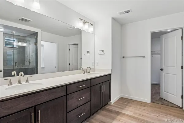 a bathroom with a double vanity sink and mirror