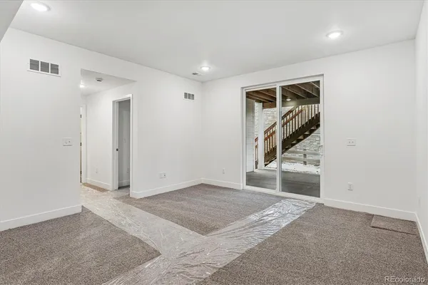 a view of a livingroom with wooden floor and white walls