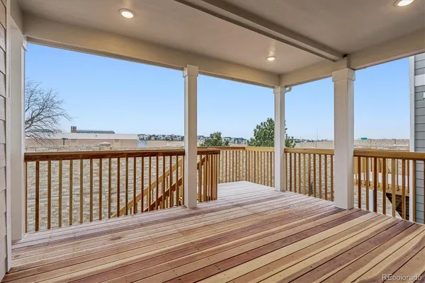 a view of a balcony with wooden floor
