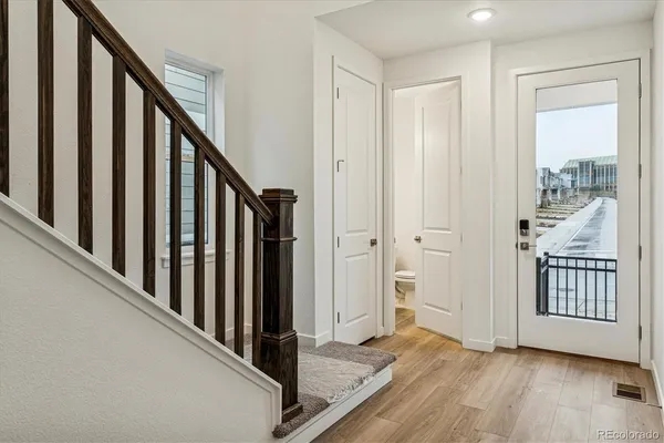 a view of an entryway with wooden floor and stairs