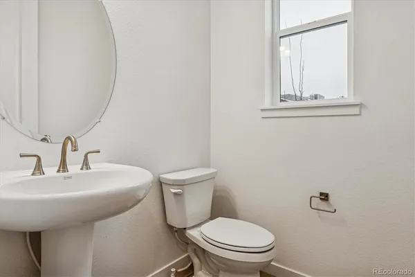 a white toilet sitting next to a bathroom sink