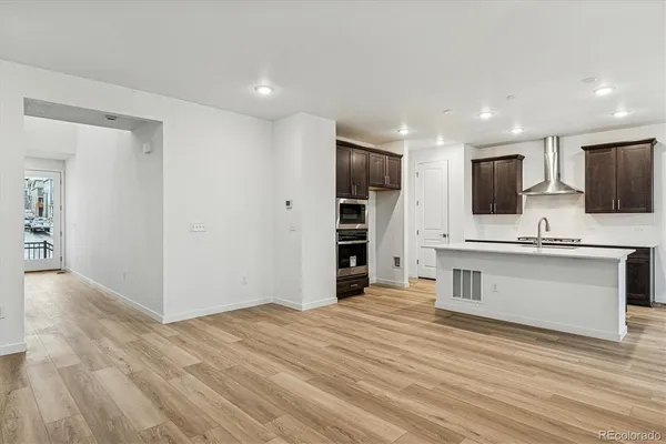a view of kitchen with sink microwave and refrigerator