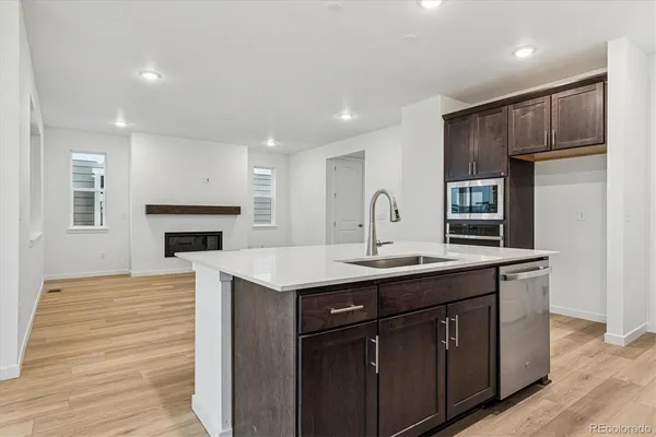 a kitchen with stainless steel appliances a sink stove and refrigerator