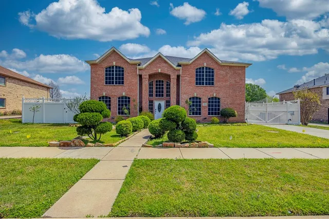 a front view of a house with a yard