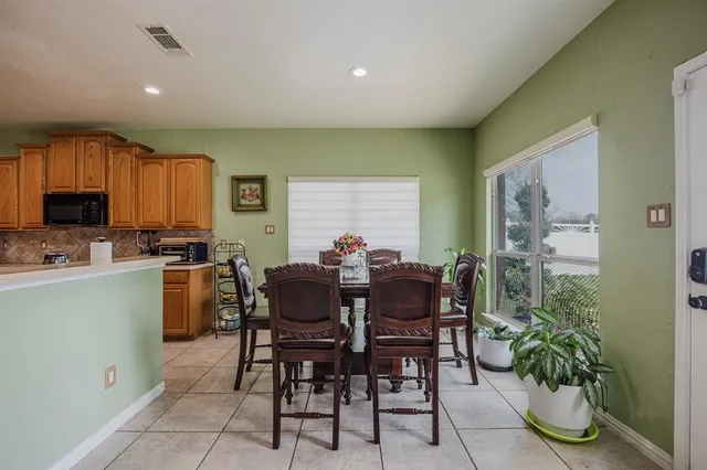 a view of a dining room with furniture and a potted plant