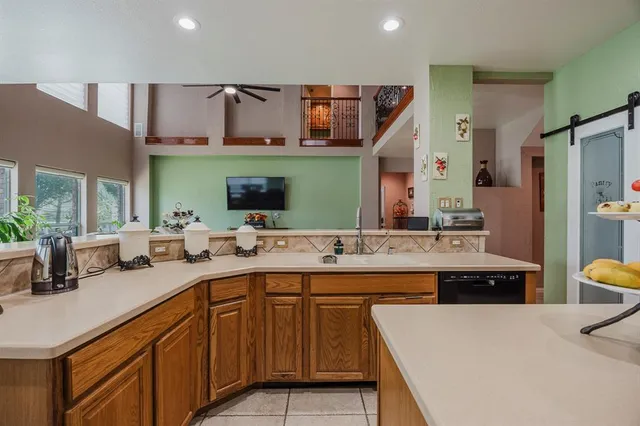 a kitchen with a sink a stove and chairs