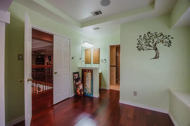 an empty room with wooden floor and closet