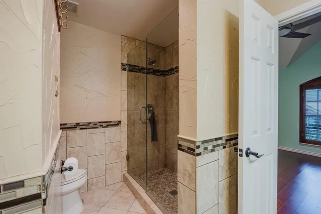 a bathroom with a glass shower door
