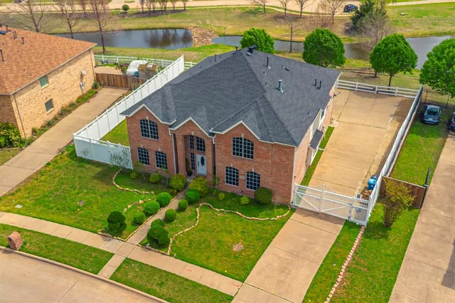 a aerial view of a house with a yard