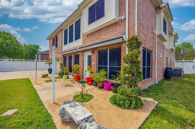 a view of a backyard with plants and a patio
