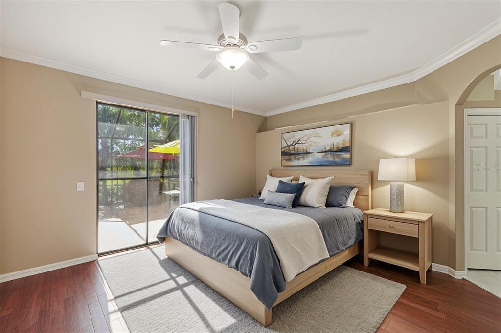 2002 Palm View Road Sarasota, FL 34240 - Photo 21 of 34 a bedroom with a large bed and a chandelier