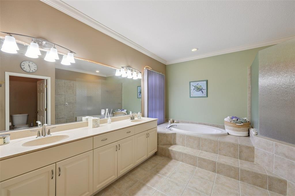 2002 Palm View Road Sarasota, FL 34240 - Photo 22 of 34 a bathroom with a double vanity sink mirror and bathtub