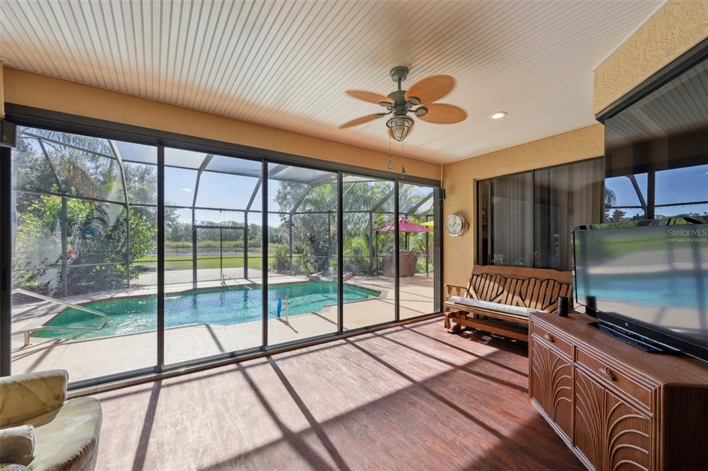 2002 Palm View Road Sarasota, FL 34240 - Photo 24 of 34 a view of a livingroom with furniture hardwood floor ceiling fan and windows
