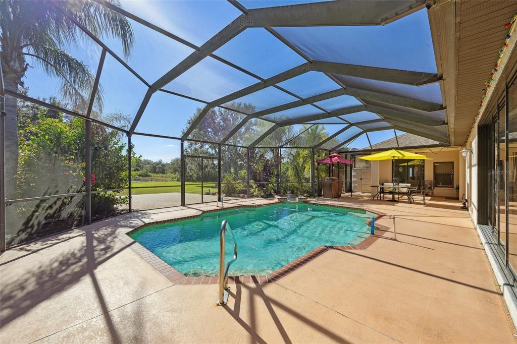 2002 Palm View Road Sarasota, FL 34240 - Photo 27 of 34 a view of a backyard with table and chairs under an umbrella