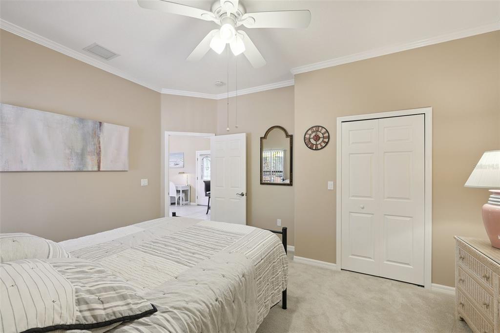 2002 Palm View Road Sarasota, FL 34240 - Photo 30 of 34 a bedroom with a bed and a chandelier