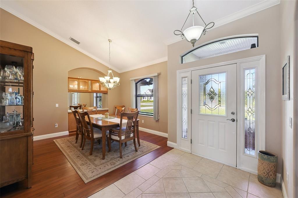 2002 Palm View Road Sarasota, FL 34240 - Photo 3 of 34 a dining room with furniture a chandelier and wooden floor