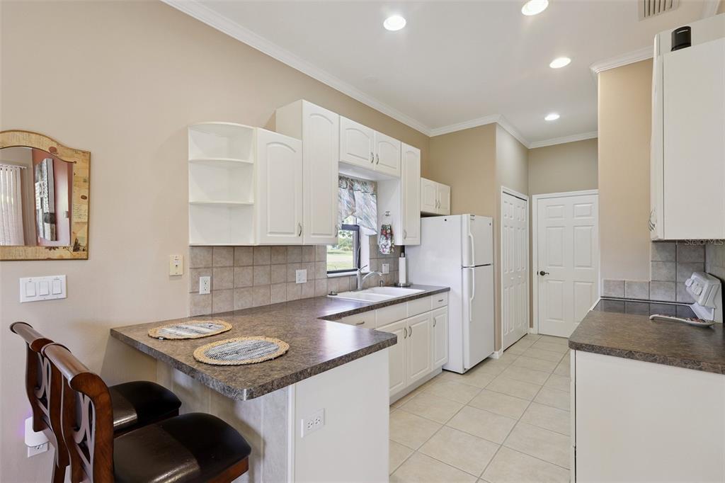 2002 Palm View Road Sarasota, FL 34240 - Photo 31 of 34 a kitchen with a sink a stove a refrigerator and chairs