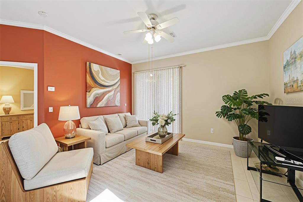 2002 Palm View Road Sarasota, FL 34240 - Photo 33 of 34 a living room with furniture a potted plant and a chandelier