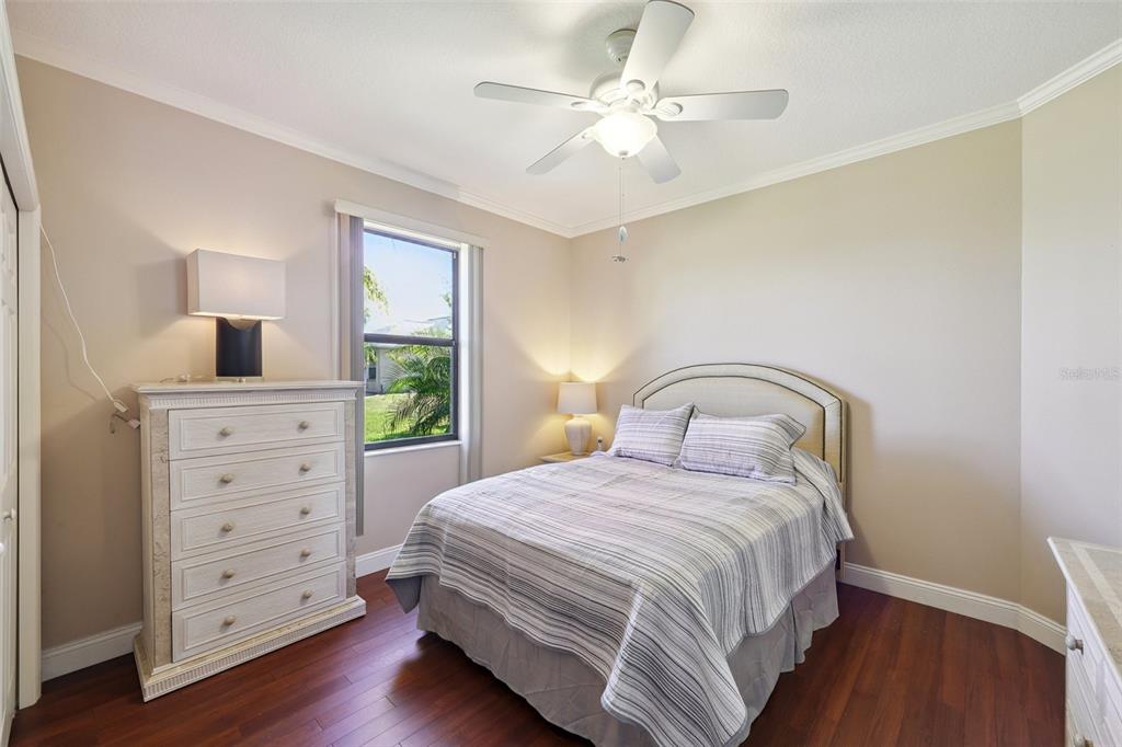 2002 Palm View Road Sarasota, FL 34240 - Photo 7 of 34 a bedroom with a bed a dresser with wooden floor