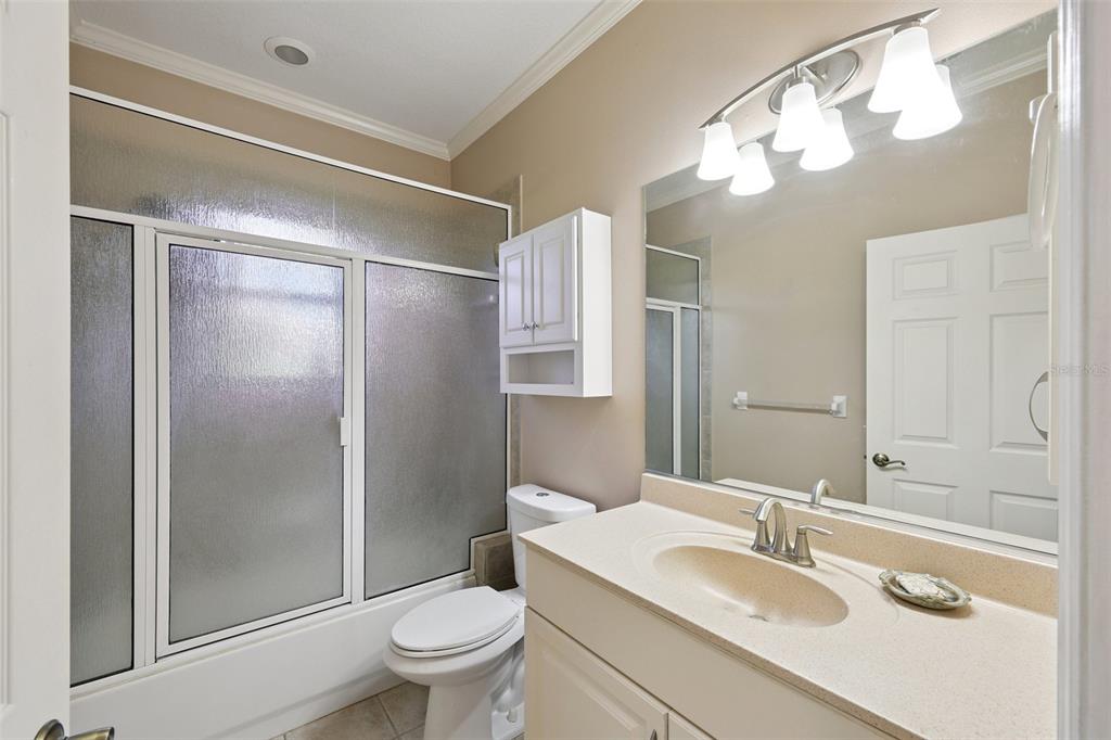 2002 Palm View Road Sarasota, FL 34240 - Photo 9 of 34 a bathroom with a sink vanity granite toilet and a mirror