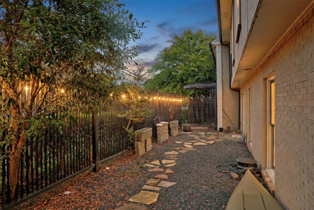 7736 Meadow Road, Unit 102 Dallas, TX 75230 - Photo 3 of 25 a view of a patio with table and chairs and wooden fence