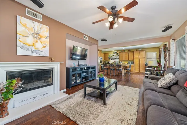 a living room with furniture a fireplace and a flat screen tv