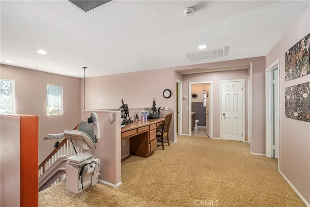 a view of a livingroom with furniture and a bedroom
