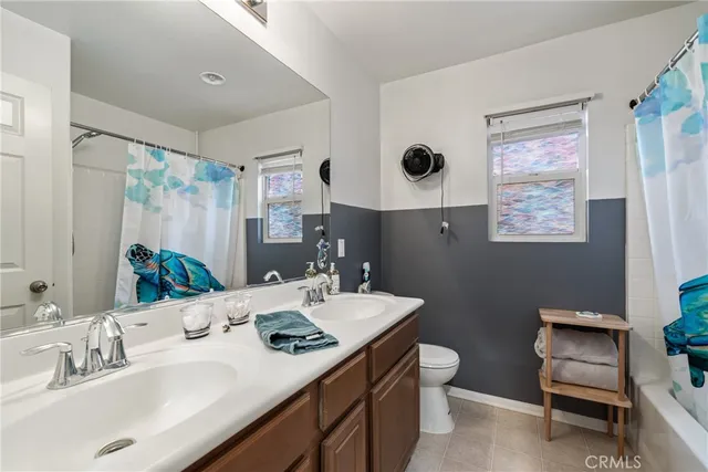 a bathroom with a double vanity sink and a mirror
