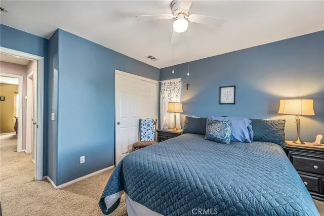 a bedroom with a large bed and a chandelier