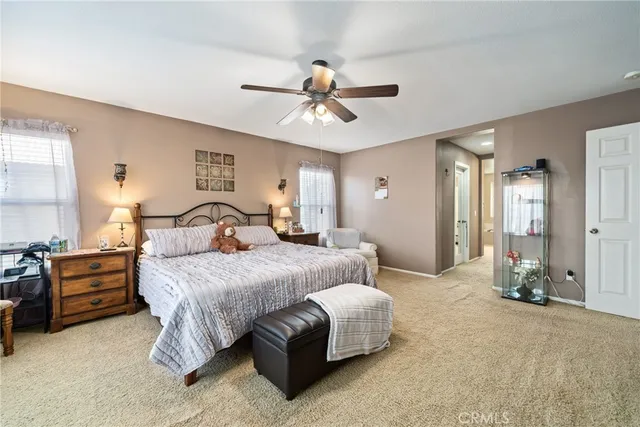 a bedroom with a bed and ceiling chandelier