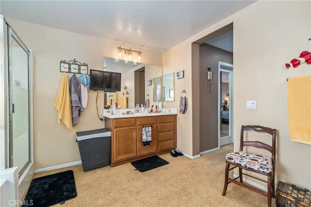 a room with kitchen island stainless steel appliances a sink and a refrigerator
