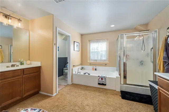 a bathroom with a tub sink shower and mirror