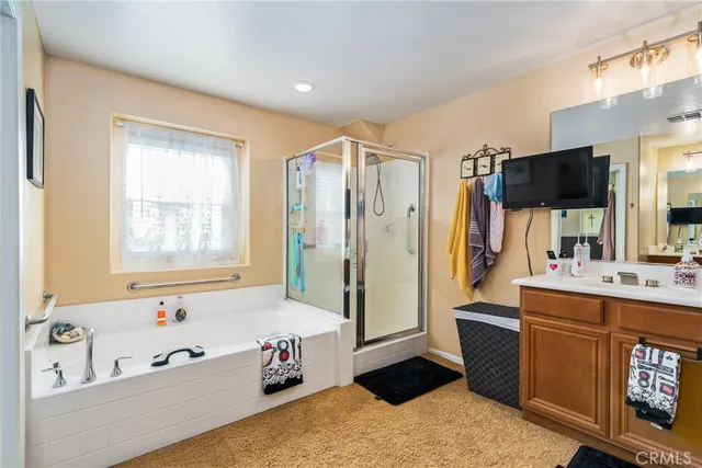 a spacious bathroom with a tub sink and mirror