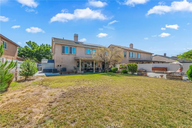 a front view of a house with a garden and plants