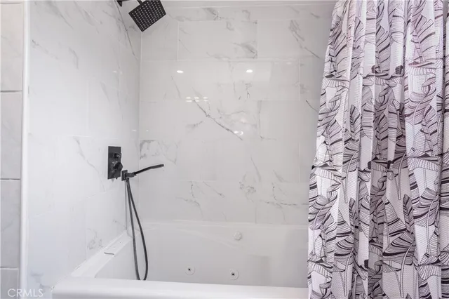 a bathroom with a bathtub and a shower