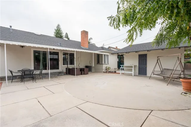 a swimming pool with outdoor seating and yard